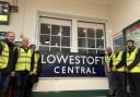 Lowestoft Central Project team members with the former station 'running in board' sign. Picture: Wherry Lines CRP/Lowestoft Central Project