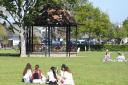 People enjoying the warm weather near the bandstand in Nicholas Everitt Park, Oulton Broad.