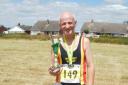 Waveney Valley AC\'s Bill Kingaby, with the first place age category trophy. Picture: Bill Kingaby