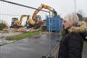 Nicola Taggart, 63, watches on as her clifftop chalet is demolished in Pakefield.