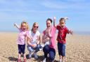 Youngsters enjoying the beach in the sun in Aldeburgh