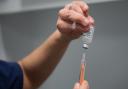 A doctor prepares to administer a dose of the Oxford-AstraZeneca Covid-19 vaccine.