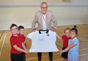 Terry Butcher with a signed replica 1990 England World Cup shirt in the Terry Butcher Sports Hall. Picture: Mick Howes