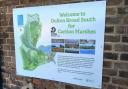 New signage at Oulton Broad South rail station encourages visitors of Carlton Marshes to travel by train