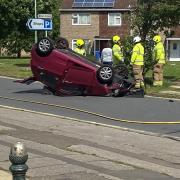 The scene of the crash, with the overturned car on Weston Road, Lowestoft.