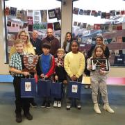 Back row, L-R: Caroline Moyse (assistant headteacher, Dell Primary School), Cllr John Pitts, Gary Harewood (Head Judge), Natasha Harewood, Cllr Nasima Begum (deputy mayor).
Front row: winners from Dell Primary with their prizes.