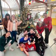 Squawk members decorating the Seagull Theatre sponsored Christmas tree at East Point Pavilion.