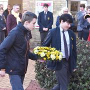 Waveney Youth Council representatives lay a wreath by the Kindertransport plaque at Lowestoft rail station.