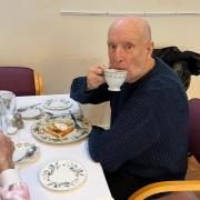 A resident at the Dell care home in Lowestoft enjoys breakfast at the reopened day care centre.