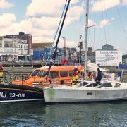 Lowestoft lifeboat with the French yacht it towed back into harbour.