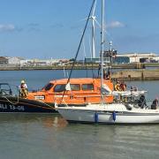 Lowestoft Lifeboat with the stranded yacht. Picture: Mick Howes