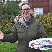 Rev Sharon Lord blessing a tray of herring. Picture: Mick Howes