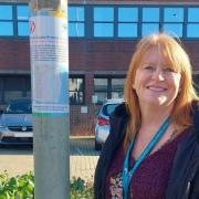Rachel Tucker, from the East Suffolk Communities Team, with one of the signs. Picture: East Suffolk Council