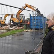 Nicola Taggart, 63, watches on as her clifftop chalet is demolished in Pakefield.