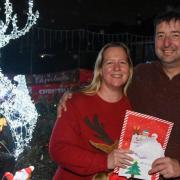 Suzanne Chapman and Paul Hammond with their Christmas lighs, on Kilburn Road in Pakefield, which is raising money for charity.
