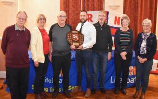 The winning \'Navigators\' team with the Lowestoft Lifeboat quiz trophy presented by RNLI crewman Ben Arlow.