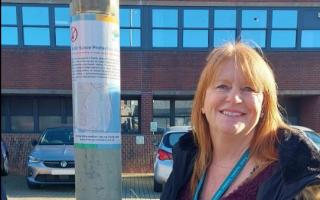 Rachel Tucker, from the East Suffolk Communities Team, with one of the signs. Picture: East Suffolk Council