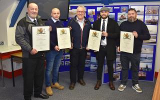 Lowestoft Lifeboat crew members collecting their awards from Richard Musgrove. L-R: Andrew Smith, James Tacon, Richard Musgrove, Ben Arlow and Michael Beadle. Picture: Mick Howes